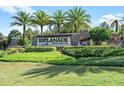 Elegant entrance to Esplanade Golf & Country Club showcasing lush landscaping and the community sign at 12856 Sorrento Way, Bradenton, FL 34211