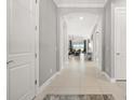 Bright hallway featuring tile floors, archways, and views of the living area at 12856 Sorrento Way, Bradenton, FL 34211