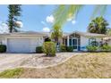 Inviting one-story home featuring manicured landscaping and a spacious two-car garage at 1304 Alton Rd, Port Charlotte, FL 33952