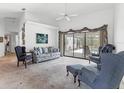 Bright living room featuring vaulted ceilings, plush seating, and sliding glass doors to the lanai at 1304 Alton Rd, Port Charlotte, FL 33952