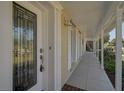 Inviting covered porch with decorative front door, creating an elegant entryway to the home at 149 Small Se St, Port Charlotte, FL 33952