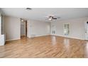 Bright living room featuring hardwood floors, neutral walls, and large windows with plantation shutters at 149 Small Se St, Port Charlotte, FL 33952