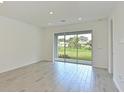 Bright sunroom with tile flooring and large sliding glass doors overlooking the backyard at 15033 Shady Palms Ln, Nokomis, FL 34275