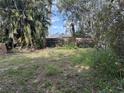Backyard shot of a single story home with a wooden fence at 1511 11Th W Ave, Palmetto, FL 34221