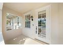 Welcoming entryway with a decorative front door and sidelight window at 1519 Napoli E Dr, Sarasota, FL 34232