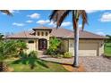 Lovely home exterior with well-maintained lawn, terracotta roofing, and an attached two-car garage at 1736 Suzi St, Punta Gorda, FL 33950