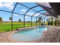 Relaxing enclosed pool area with brick-paved decking offering serene views of the surrounding golf course at 1736 Suzi St, Punta Gorda, FL 33950