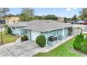 This home offers an attached garage, side yard, and well-maintained landscaping at 1801 Forest Dr, Oldsmar, FL 34677