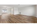 A spacious, light-filled living room featuring sleek wood flooring and crisp, white walls at 1801 Forest Dr, Oldsmar, FL 34677