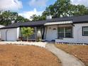 Inviting single-story home with a freshly landscaped yard, featuring a mix of rock and mulch at 1802 19Th W Ave, Bradenton, FL 34205