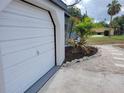 Attached garage with a newly landscaped yard featuring fresh mulch and decorative stone accents at 1802 19Th W Ave, Bradenton, FL 34205