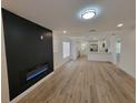 Bright, open-concept living room with hardwood floors and a sleek, modern fireplace at 1802 19Th W Ave, Bradenton, FL 34205