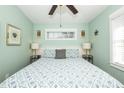 Cozy bedroom with a blue and white seashell patterned comforter, tropical decor and lots of light at 211 65Th St, Holmes Beach, FL 34217