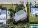 An aerial view shows the property and surrounding area from above showcasing the home and landscaping at 221 85Th St, Holmes Beach, FL 34217
