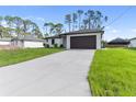 Beautifully landscaped single-story home with an attached two-car garage and a long concrete driveway at 2638 Hagerick Ln, North Port, FL 34288