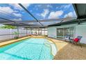 Relaxing screened-in pool area with lounge chairs, perfect for enjoying sunny days at 3808 Cape Vista Dr, Bradenton, FL 34209
