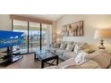 Comfortable living room with sliding glass doors and a view of the community at 4325 46Th W Ave # 203, Bradenton, FL 34210