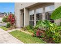 Charming front yard featuring colorful flowers, green plants, and a well-maintained lawn, creating a welcoming entrance at 4475 Sandner Dr, Sarasota, FL 34243