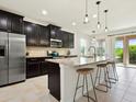 Modern kitchen with stainless steel appliances, a large island, and barstool seating at 4615 73Rd E St, Bradenton, FL 34203