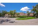 Scenic view of condo complex featuring mature trees and manicured lawns, offering a serene living environment at 4650 Ringwood Meadow # 37, Sarasota, FL 34235