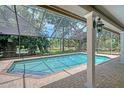 Beautiful in-ground pool with screened enclosure offering a private backyard oasis at 4917 Leatha Ln, Sarasota, FL 34232