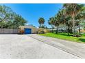 Charming yellow single-story home with a blue garage door and nice landscaping at 5223 Shadow Lawn Dr, Sarasota, FL 34242