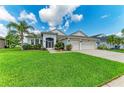 Charming single-story home with well-kept lawn, front garden, and a two-car garage at 5319 120Th E Ave, Parrish, FL 34219