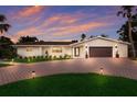 Charming single-story home with brick driveway, manicured lawn, and a two-car garage, perfect for modern living at 5581 Shadow Lawn Dr, Sarasota, FL 34242