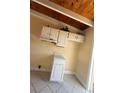 Compact kitchen with white cabinets, marble-look countertops, and essential appliances at 6006 Midnight Pass Rd # 48, Sarasota, FL 34242