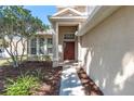 Home's entrance is enhanced by a covered porch and decorative plants at 6032 36Th E Ct, Ellenton, FL 34222