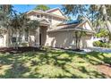 Inviting home featuring manicured lawn, lush trees, and a two-car garage at 6032 36Th E Ct, Ellenton, FL 34222