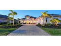 Beautifully landscaped home with a paved driveway and three-car garage at 7838 Bowspirit Way, Lakewood Ranch, FL 34202