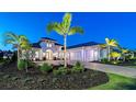 Stunning home exterior with a multi-car garage, brick driveway and meticulous landscaping at 7838 Bowspirit Way, Lakewood Ranch, FL 34202