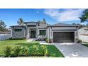 Beautiful modern home featuring stone accents, professional landscaping, and a freshly sealed driveway at 805 Padua Ct, Nokomis, FL 34275
