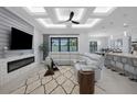 Spacious open-concept living room featuring a fireplace, modern ceiling, and neutral decor at 805 Padua Ct, Nokomis, FL 34275