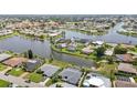 Stunning aerial view of waterfront homes with lush landscaping and private docks in a serene community at 965 E Gondola Dr, Venice, FL 34293