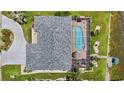 Aerial view of a private backyard pool, with a screened enclosure, adjacent to a boat dock at 965 E Gondola Dr, Venice, FL 34293