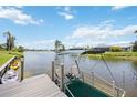Waterfront property features a private dock with kayaks, and a canopy offering scenic views at 965 E Gondola Dr, Venice, FL 34293