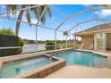 Relaxing screened-in pool and spa with a serene lake view, perfect for outdoor enjoyment at 11022 Pine Lilly Pl, Lakewood Ranch, FL 34202
