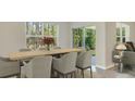 Dining area featuring a wooden table, comfortable seating, and sliding door access to outdoor living at 10821 Gentle Current Way, Parrish, FL 34219