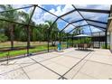 Expansive screened-in patio featuring outdoor seating and a view of the serene backyard at 11794 Forest Park Cir, Bradenton, FL 34211