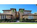 Inviting beige condo building with well-manicured landscaping and a clear blue sky backdrop at 1241 Riverscape St # B, Bradenton, FL 34208