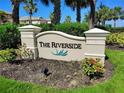 Attractive entrance to the Riverside community with a well-maintained sign and flower beds at 1241 Riverscape St # B, Bradenton, FL 34208
