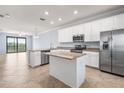 Bright, open kitchen features granite countertops, island, and stainless steel appliances at 17118 Vardon Ter # 404, Bradenton, FL 34211