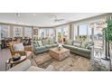 Bright and airy living room with comfortable seating, large windows, and access to a balcony with ocean views at 2201 Avenue C, Bradenton Beach, FL 34217