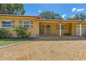 Inviting single-story home featuring a covered entry, gravel yard, and tidy landscaping at 2702 45Th S St, Gulfport, FL 33711
