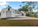 View of the property featuring a spacious garage and long driveway at 31 Twig Ct, Port Charlotte, FL 33954