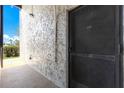 Covered entry way featuring exterior wall and door with security screen at 3253 Beneva Rd # 103, Sarasota, FL 34232