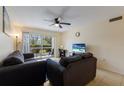 Comfortable living room features neutral walls, tile floors, and sliding doors to outdoor patio at 3253 Beneva Rd # 103, Sarasota, FL 34232
