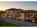 A luxurious backyard features a swimming pool, an outdoor kitchen, and comfortable lounge areas at 3799 Flamingo Ave, Sarasota, FL 34242